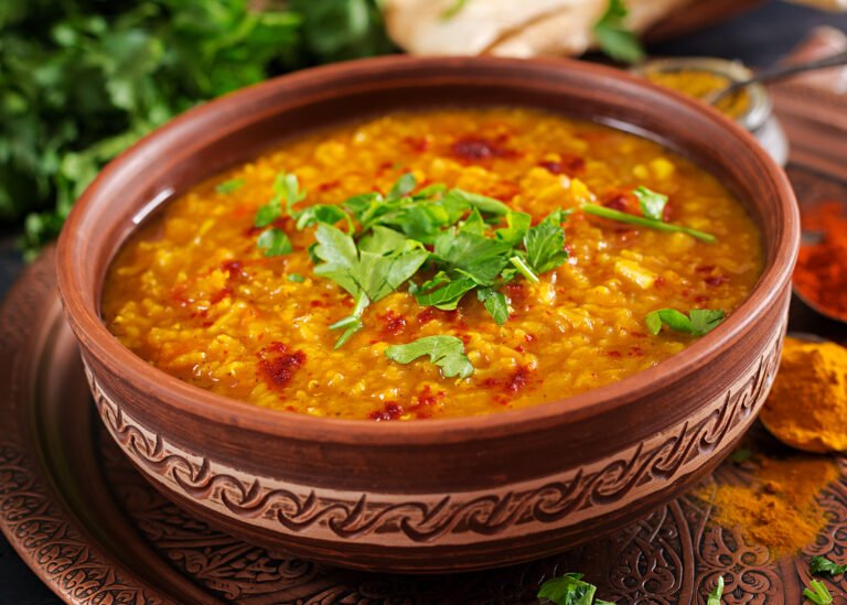 indian-dhal-spicy-curry-bowl-spices-herbs-rustic-black-wooden-table