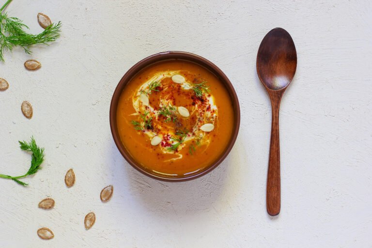 Roasted pumpkin and carrot soup with cream, black pepper and pum